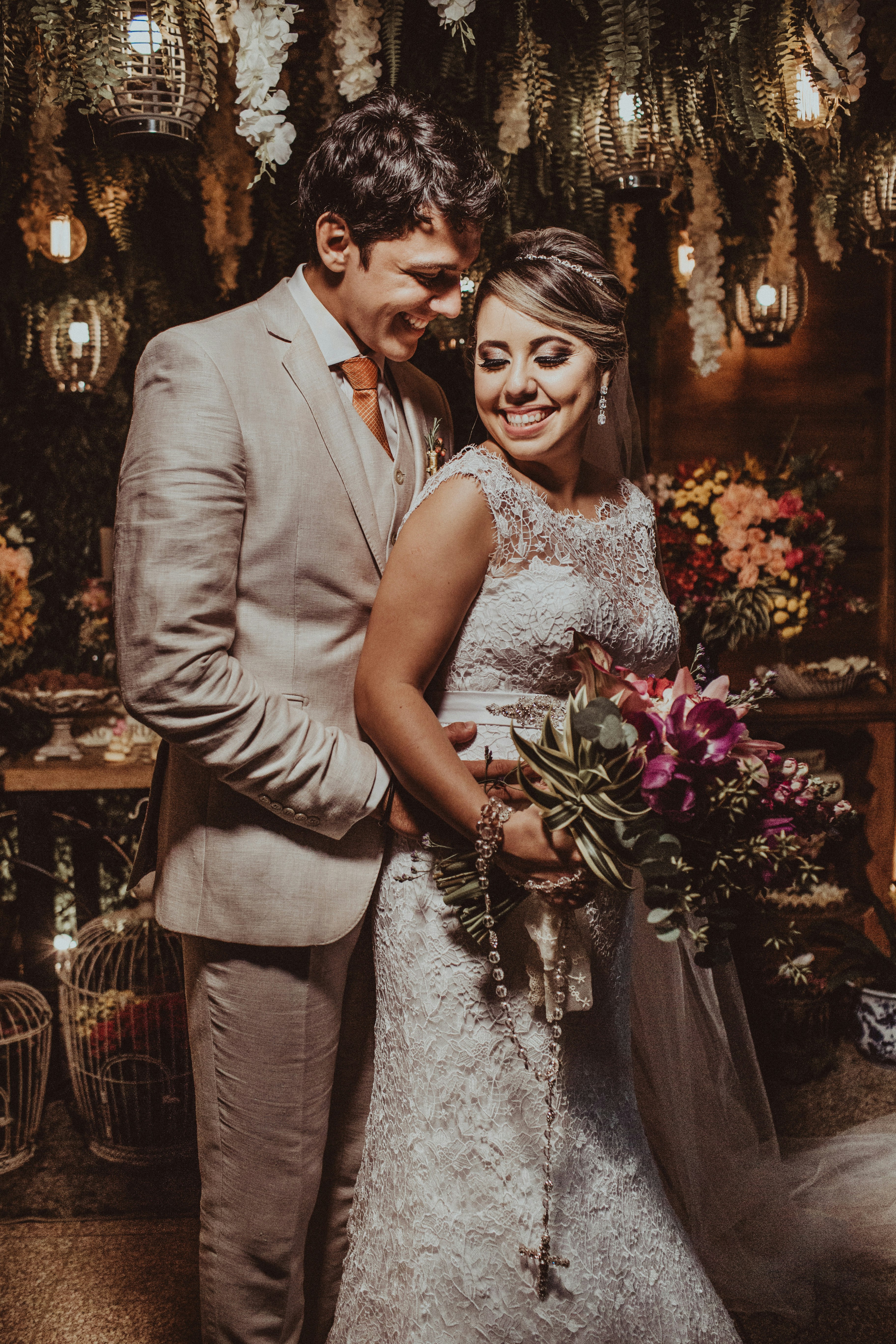 man in gray suit jacket beside woman in white floral dress